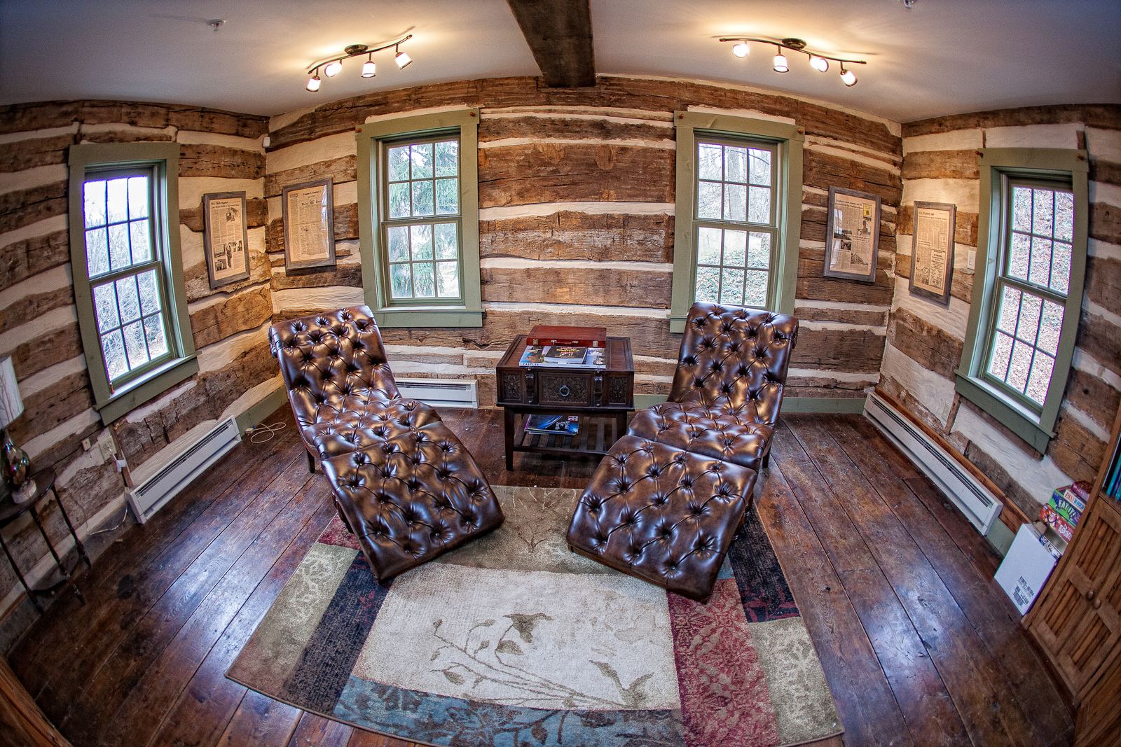 Sitting room with leather chairs and log walls